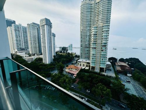 a view from a balcony of a city with tall buildings at 10pax 3-Bedroom l Seaview l Georgetown l Gleneagles l Mansion One in George Town