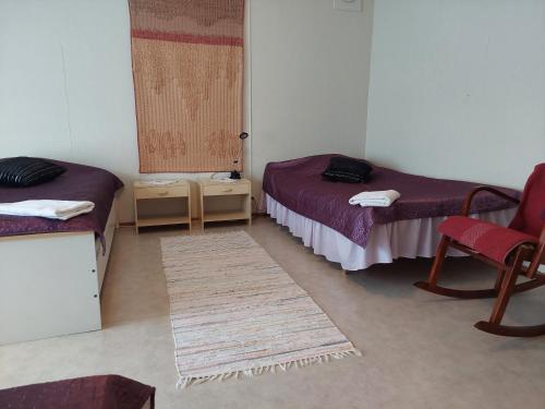 Postel nebo postele na pokoji v ubytování Kolmostien kotokortteeri