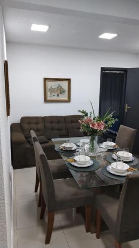 a dining room with a table and a couch at Stefanich Aparthotel in Ciudad del Este