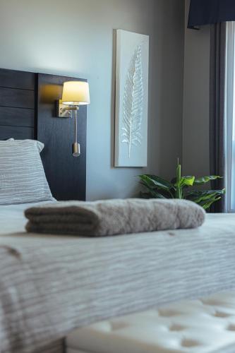 Una cama o camas en una habitación de Motel le Point de Vue