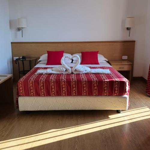 two swans are sitting on top of a bed at Hotel Marco Polo Airport hotel in Campalto