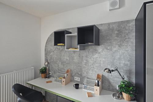 a kitchen with a white counter and a sink at Zeus Apartments Economy in Lublin
