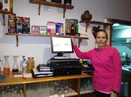 a woman standing in front of a desk with a computer at Casas Rurales Amparo Las Hayas in Valle Gran Rey
