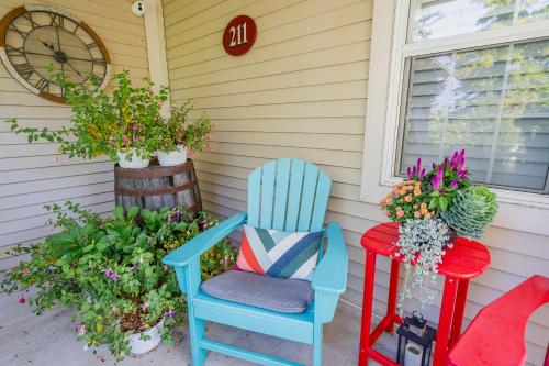 a porch with two chairs and a table with flowers at Old Town Country Landing in Niagara on the Lake