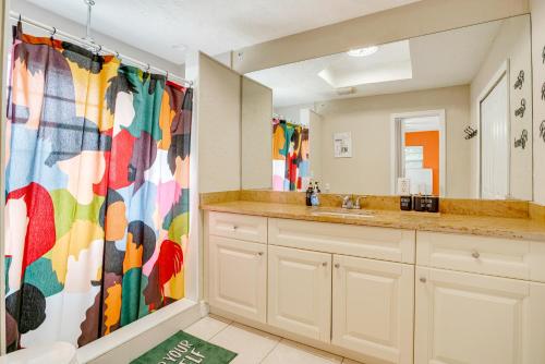 a bathroom with a shower with a colorful shower curtain at 4BR Naples Getaway Pool, Gazebo & Near Beach in Naples