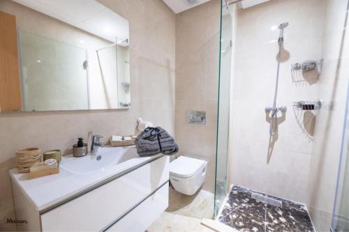 a bathroom with a toilet and a sink and a shower at Luxury Suite Mannesmann - Seaview in Mohammedia