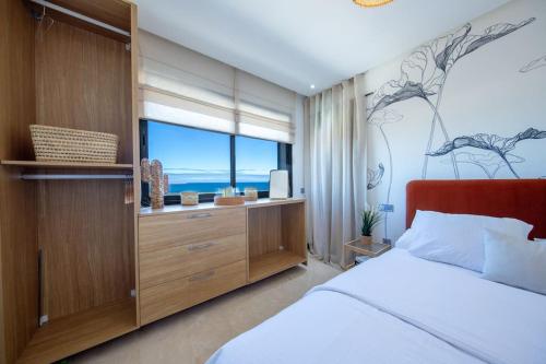 a bedroom with a bed and a large window at Luxury Suite Mannesmann - Seaview in Mohammedia
