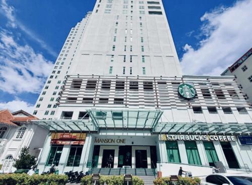 a tall white building with a clock on it at 10pax 3-Bedroom l Seaview l Georgetown l Gleneagles l Mansion One in George Town