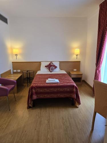 a hotel room with a bed and two chairs at Hotel Marco Polo Airport hotel in Campalto