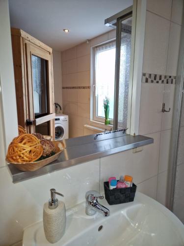 a bathroom with a sink and a mirror at Ferienhaus Feuerstein in Elend