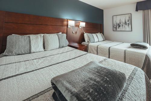Una cama o camas en una habitación de Motel le Point de Vue