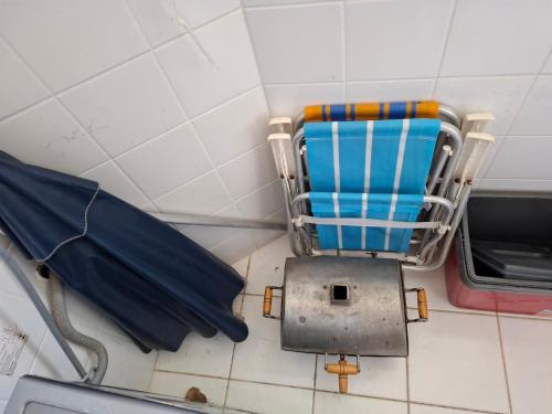 a blue chair and an umbrella in a room at Ilhéus Temporada in Ilhéus
