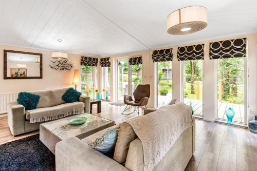 a living room with a couch and a table at Chycara House in Truro
