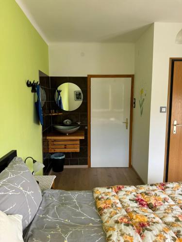 a bedroom with a bed and a mirror on the wall at Haus Alpenland in Mariazell