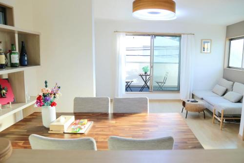 a living room with a table and chairs and a couch at 雅舍11 Osaka house new open一軒家貸切 in Osaka