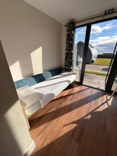 a bedroom with a bed and a large window at Aran Islands Camping & Glamping in Kilronan