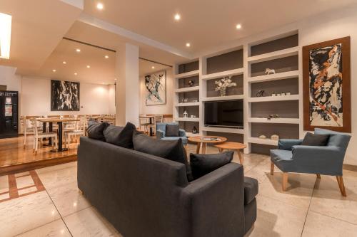a living room with couches and a dining room at Up Congreso Hotel in Buenos Aires