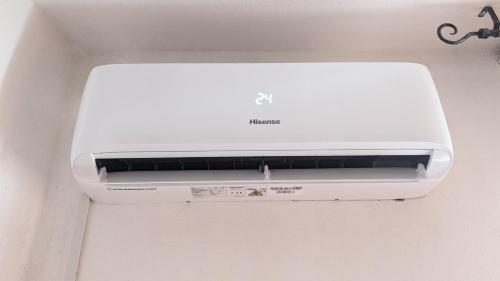 a white printer sitting on top of a wall at Appartamento Nerium - Cala di Seta in Calasetta