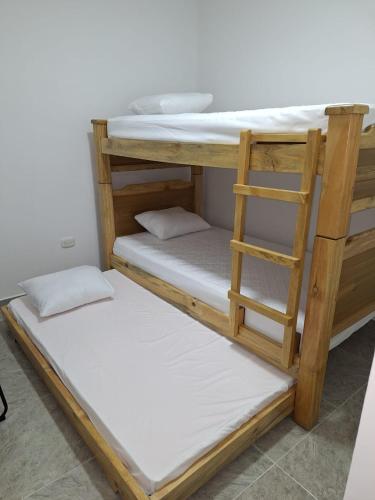 two bunk beds in a room with a ladder at Apartahotel- Alojamiento Familiar- Apartamentos Privados Kira in Buenavista