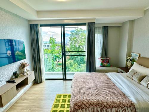 a bedroom with a large bed and a large window at Near Central Festival- 5mims Walk- Infinity Pool & Comfort Room@The One Chiang Mai Condo in Chiang Mai