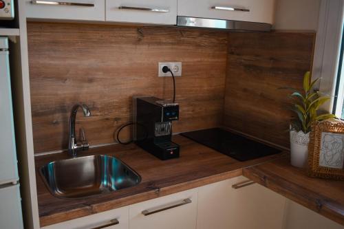 a kitchen counter with a sink and a coffee maker at Estevi Apartment in Kavala