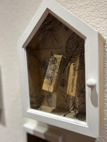 a white wooden box with someones reflection in it at La Casetta Dei Sognatori in Valfurva