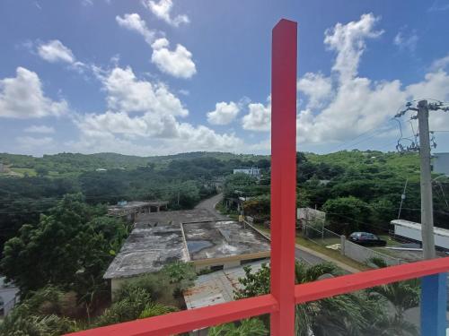 a red cross on top of a building with a road at Rooster Run Camping is a - rooftop & elevated camping experience! Incredible views of The Rain Forrest and Culebra across the Atlantic Ocean - Tents, towels, comfortable Air Beds, Warm Shower-Central Location- 5 beaches -25 min walk & Ferry is 20 min in Vieques