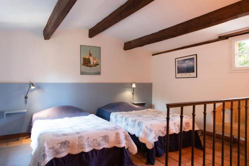 une chambre avec deux lits dans une pièce dans l'établissement Les Gites du Merle, à Cogolin