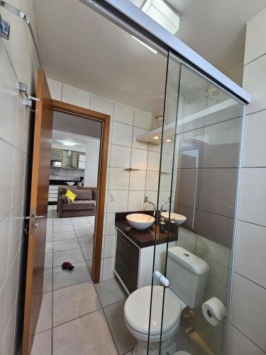 a bathroom with a toilet and a sink at Apto.napraia BEACH 901 em Piçarras com vista mar in Piçarras