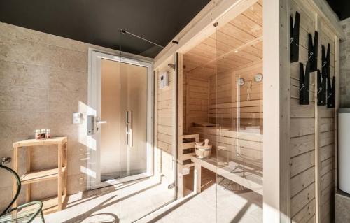 a large bathroom with a shower and a glass door at Ô songes de Saxel in Saxel