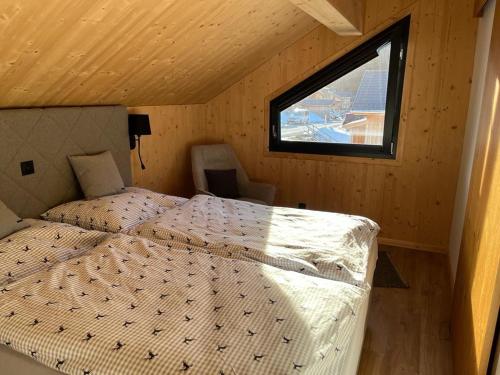 a bedroom with a bed in a room with a window at Bergchalet K2 in Hohentauern