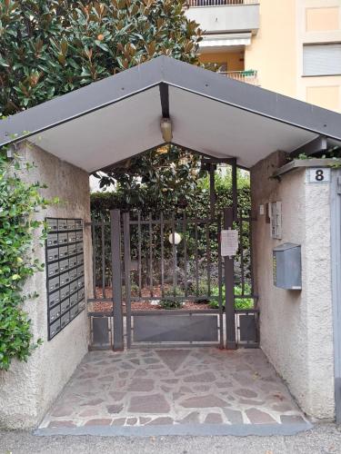 a metal gate with a black canopy over a door at CASA BEA Elegante mansarda vicina a Fiera in Pero