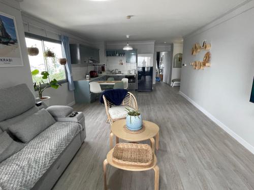 a living room with a couch and a table at Hot Deal ! Sea View Condo Cozy & Charming Si Racha in Si Racha