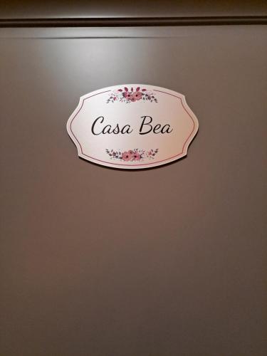 a sign that reads casa beer hanging on a wall at CASA BEA Elegante mansarda vicina a Fiera in Pero