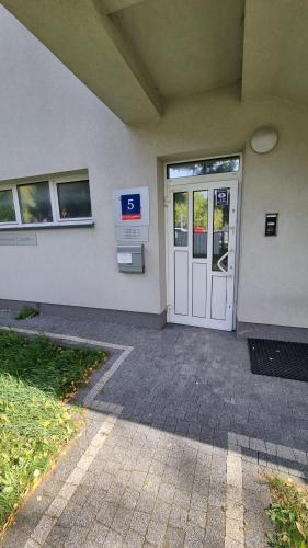 a door to a building with a gas station at Pokoje przy szpitalu - Lwowska in Rzeszów