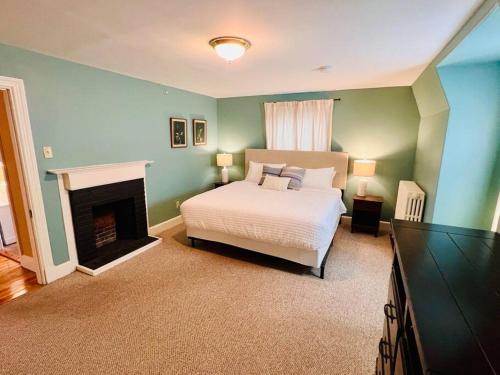 a bedroom with a bed and a fireplace at Entire Historic Home in Portland West End in Portland