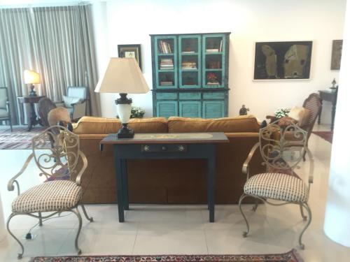 a living room with a couch and a table at Suítes Trindade in Florianópolis