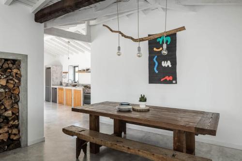 a dining room with a wooden table and a fireplace at Casa Cândida e a Casa do Lado in Abadim