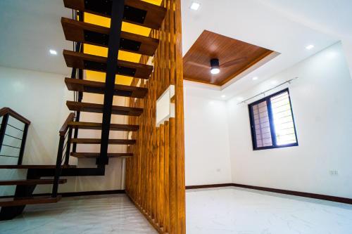a spiral staircase in a room with a window at LacambraHills Apartment2 Olongapo in Olongapo