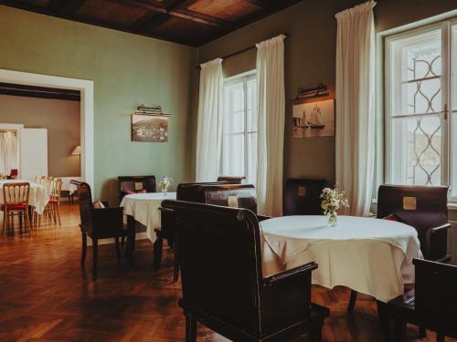 a dining room with two tables and chairs at Villa Weiss in Attersee am Attersee