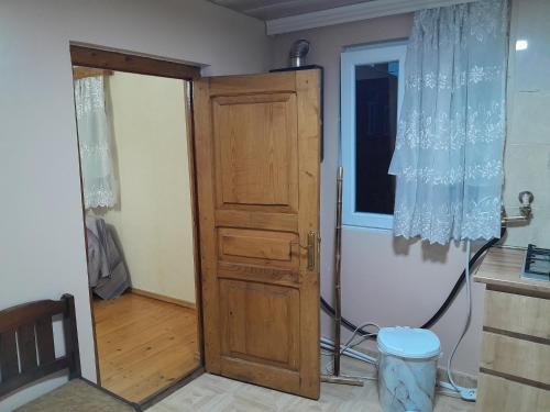 a wooden door in a room with a window at Дом где ёсть всё удобства in Khashuri