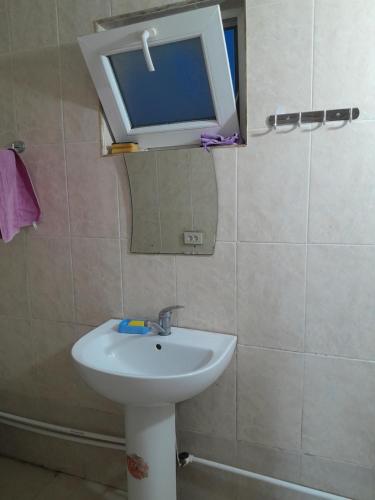 a bathroom with a sink and a mirror and a window at Дом где ёсть всё удобства in Khashuri