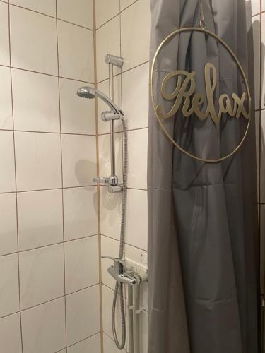 a shower with a shower curtain in a bathroom at Tiny Studio Pyskowice with parking in Pyskowice