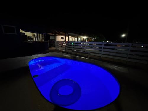 a blue object is lit up in the dark at De Las Santas Camper in Cabo Rojo