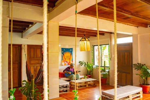 a person sitting on a couch in a living room at The Temple III, Mindo in Mindo