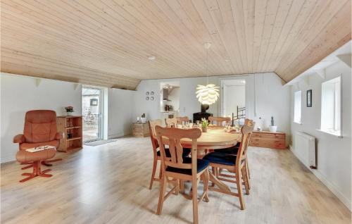 a dining room with a table and chairs at Nice Home In Spjald With 6 Bedrooms in Videbæk