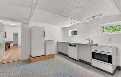 a kitchen with white counters and appliances in a room at Nice Home In Spjald With 6 Bedrooms in Videbæk