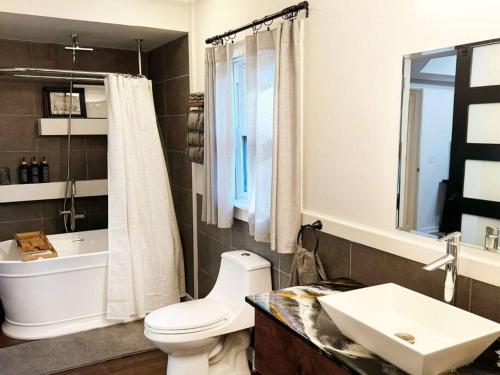 a bathroom with a white toilet and a sink at Alpharetta Home-5Brooms-6Bds-12Guests in Alpharetta