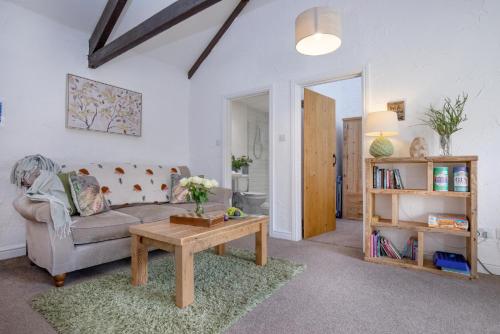 a living room with a couch and a coffee table at Daisy Cottage in Paignton
