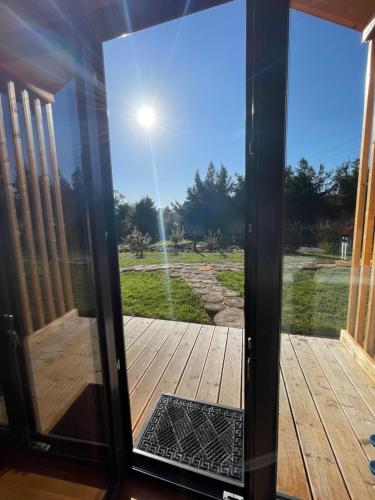 a glass door with a view of a yard at Projekt Przełazy in Przełazy